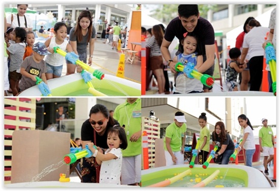 Kids and adults alike aim their water guns to race their rubber ducks to the finish line.