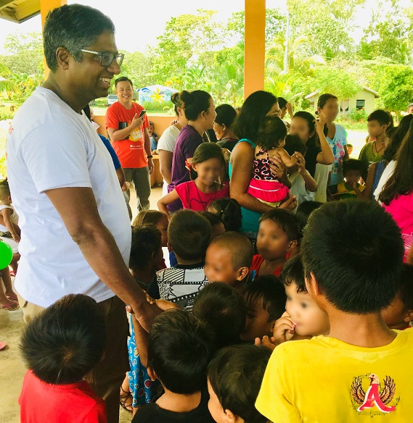 Sriram Jambunathan, General Manager for GSK Philippines, engaged with some of the children at Gawad Kalinga Sagay, Negros Occidental, where GSK donated 50 houses and a fully-equipped health center to families displaced by Typhoon Haiyan.