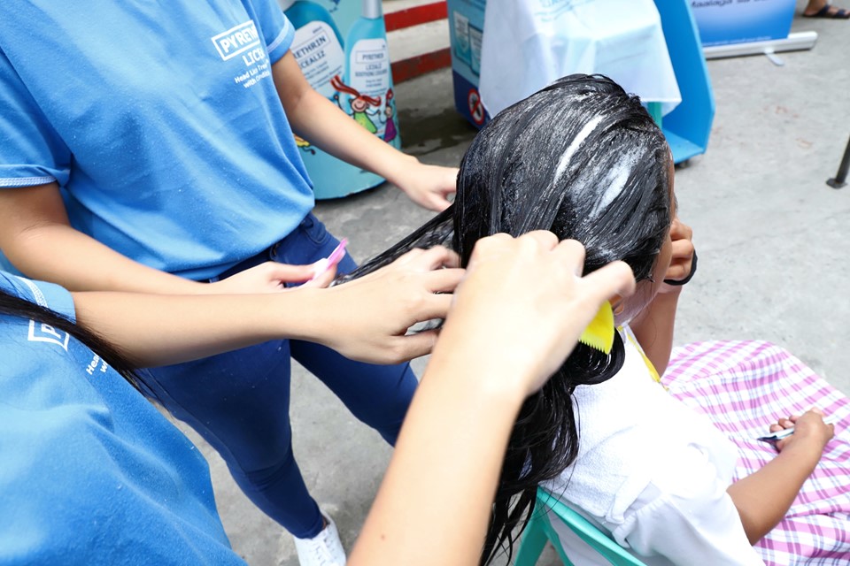 Licealiz team helped a student from Silangan Elementary School in using fine-tooth comb to detach dead lice and nits on her hair minutes after the shampooing.