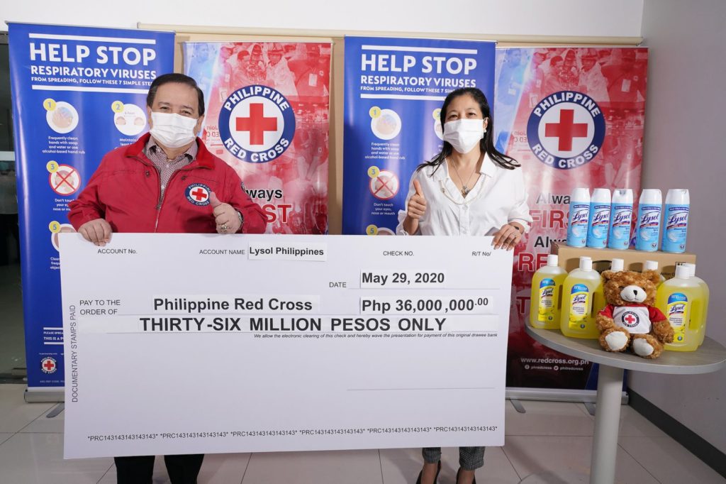 Senator Richard Gordon, Philippine Red Cross chairman, receives the Lysol Philippines donation from AleliArcilla, RB Health Philippines general manager, during turnover ceremony at the PRC headquarters in Mandaluyong City.